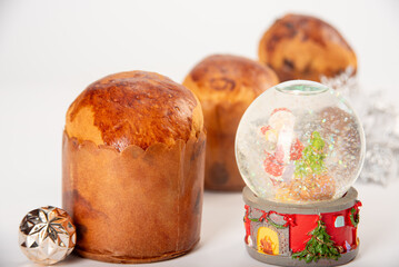 Mini panettone, mini panettone and Christmas decoration placed on white surface with white background, selective focus.