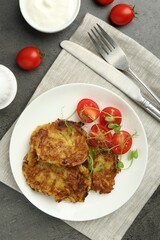 Delicious potato pancakes served on grey table, flat lay