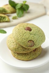 Delicious mint chocolate chip cookies on white table, closeup