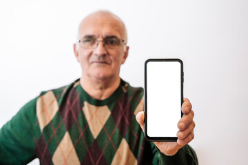 Old Man holding screen smartphone on empty white background. 