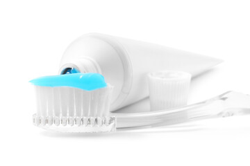 Toothbrush with toothpaste and tube isolated on white