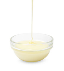 Pouring condensed milk into bowl isolated on white