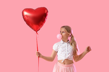 Cute trendy girl with heart-shaped balloon blowing bubble gum on pink background