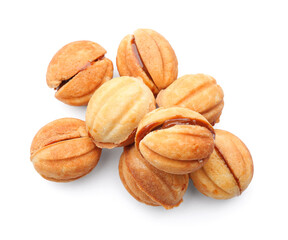 Many sweet walnut shaped cookies with boiled condensed milk on white background