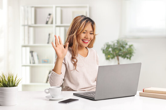 Asian woman making a video call with a laptop computer