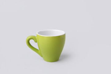 Green ceramic cup on grey background