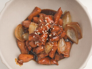 chicken cooked with teriyaki sauce in white bowl on white background