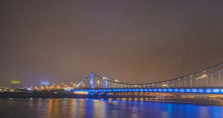 Bridge is lit up in blue and white lights