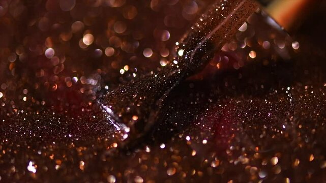 Beauty glitter nail polish UV gel background with brush. Mocha coffee color Nailpolish liquid surface, brown shellac UV gel brush, varnish, manicure salon concept, texture, backdrop 