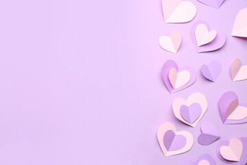 Many paper hearts on lilac background. Valentine's Day celebration