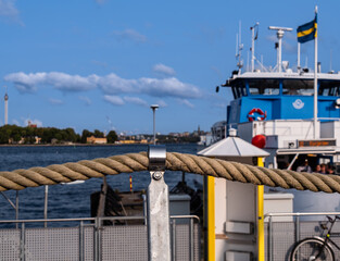 Blurred commuter ferry in Stockholm behind the rope