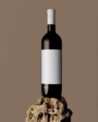 Blank white label mock up on black bottle of unlabeled wine on a stone. Alcohol bottle mockup...