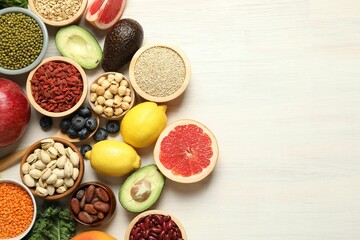 Different superfood products on white table, flat lay. Space for text