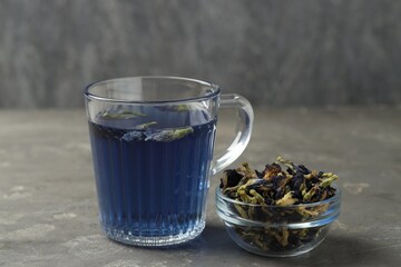 Delicious butterfly pea flower tea on gray textured table
