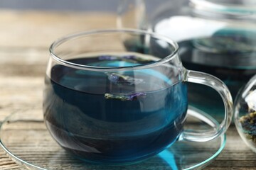 Delicious butterfly pea flower tea on wooden table, closeup