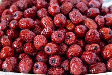 Pile of red Chinese dates (jujube). Close-up. Selective focus.