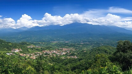 Fototapeta premium Panoramic view of a mountain village nestled in a lush green valley under a vibrant blue sky with fluffy clouds.