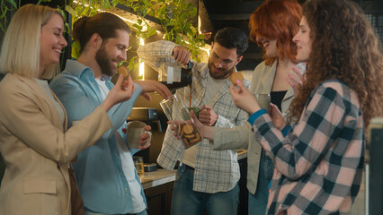 Group diverse freelance business men women male female friends drink coffee eat cookies snacks office break Arabian Caucasian guys girls happy colleagues casual team talk laugh relax drinking in cafe