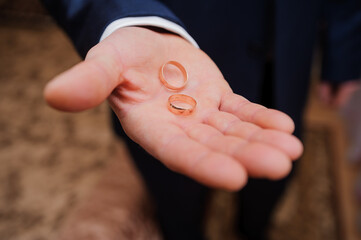 Wedding Rings Held in Palm at a Ceremony