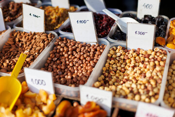 Nuts and dried fruits displayed at a local market with various prices