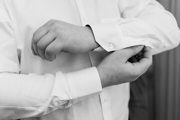 Elegantly Adjusting Cuff of a Formal White Shirt