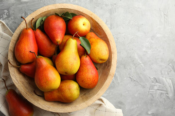 Ripe juicy pears on grey table, top view