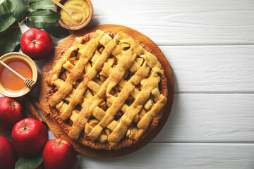 Tasty homemade apple pie and ingredients on white wooden table, flat lay. Space for text