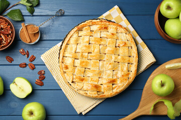 Flat lay composition with tasty homemade apple pie and ingredients on blue wooden table