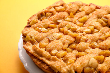 Tasty homemade apple pie on yellow background, closeup