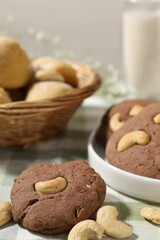 Fototapeta premium Tasty chocolate cookies with cashew on table, closeup