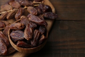 Tasty dried dates on wooden table, closeup. Space for text