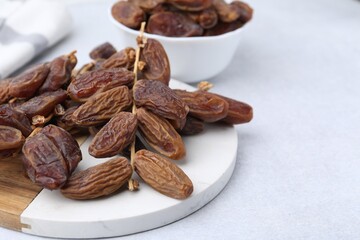 Tasty dried dates on light table, closeup