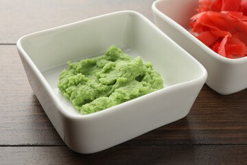 Hot wasabi paste and ginger on wooden table, closeup