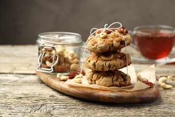 Tasty cookies with nuts on wooden table, closeup