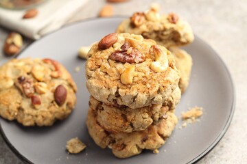 Tasty cookies with nuts on gray table, closeup