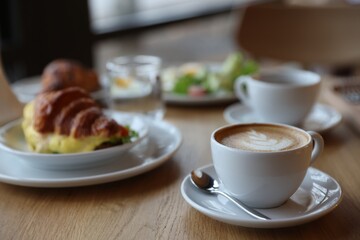 Delicious breakfast served on wooden table in cafe, closeup
