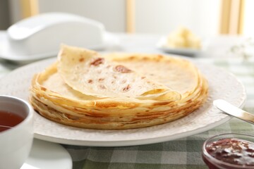 Stack of delicious crepes on table, closeup