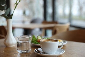 Delicious breakfast served on wooden table in cafe