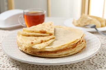 Tasty crepes served on table, closeup view