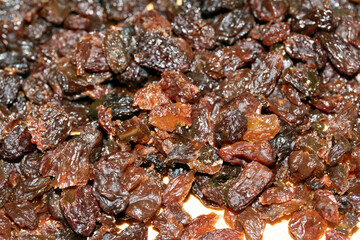 Close Up of Chopped Saltanas Raisins with Knife on Chopping Board