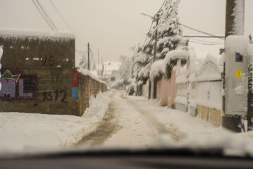 December 24, 2024 - Belgrade, Serbia. Looking through the windshield at the snow in the suburbs of Belgrade and the streets that have not been cleaned and adapted for drivers.