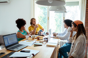 Group of young people studying together in modern home