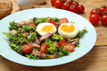 Delicious fresh tuna salad on wooden table, closeup