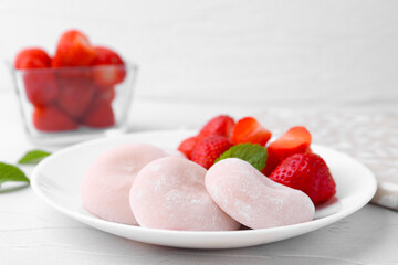 Delicious mochi and strawberries on white table, closeup