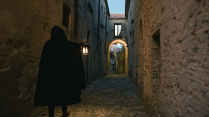 Dark Silhouette Moves Through Ancient Town alleys 