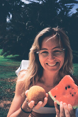 Tourist smiling and holding arancino and watermelon slice in italy