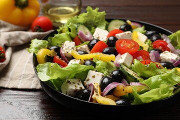 Delicious fresh Greek salad on wooden table, closeup