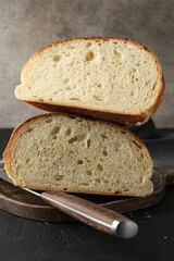 Pieces of fresh bread on black table, closeup