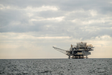 Oil Rig Rises Over The Water Along California Coast