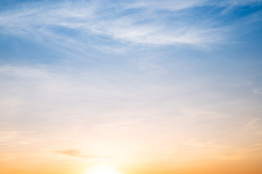 Sky,sunset, beautiful , luxury soft gradient orange gold clouds and sunlight on the blue sky perfect for the background, Sunrise on morning or everning in winter warm time ,Twilight summer,silhouette - Powered by Adobe